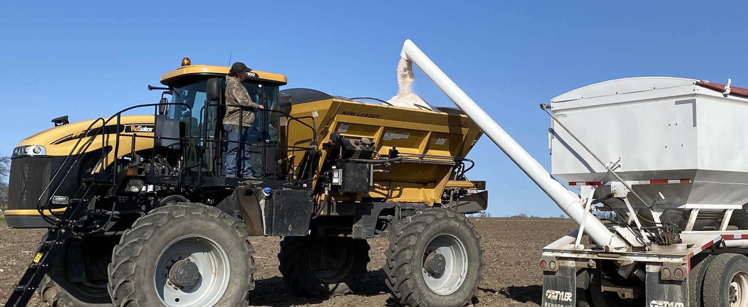 Harvex grain trucking with blue skies