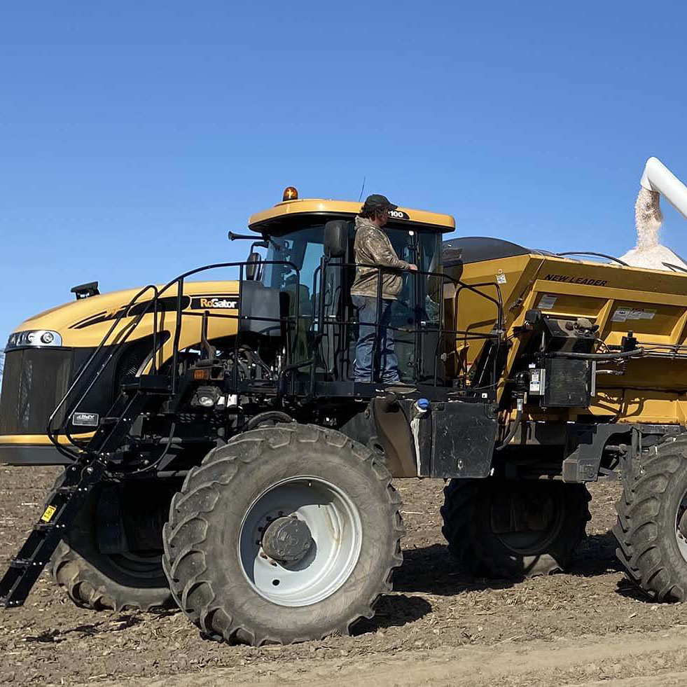 Harvex grain trucking with blue skies