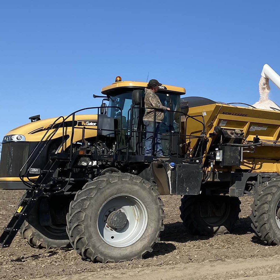 Harvex grain trucking with blue skies